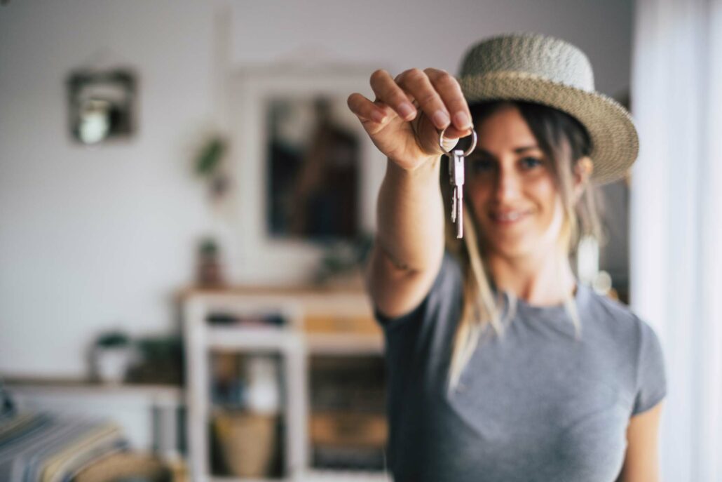 Woman holding keys depicting new house